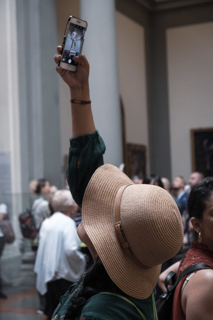 Woman taking picture of Michelangelo's David
