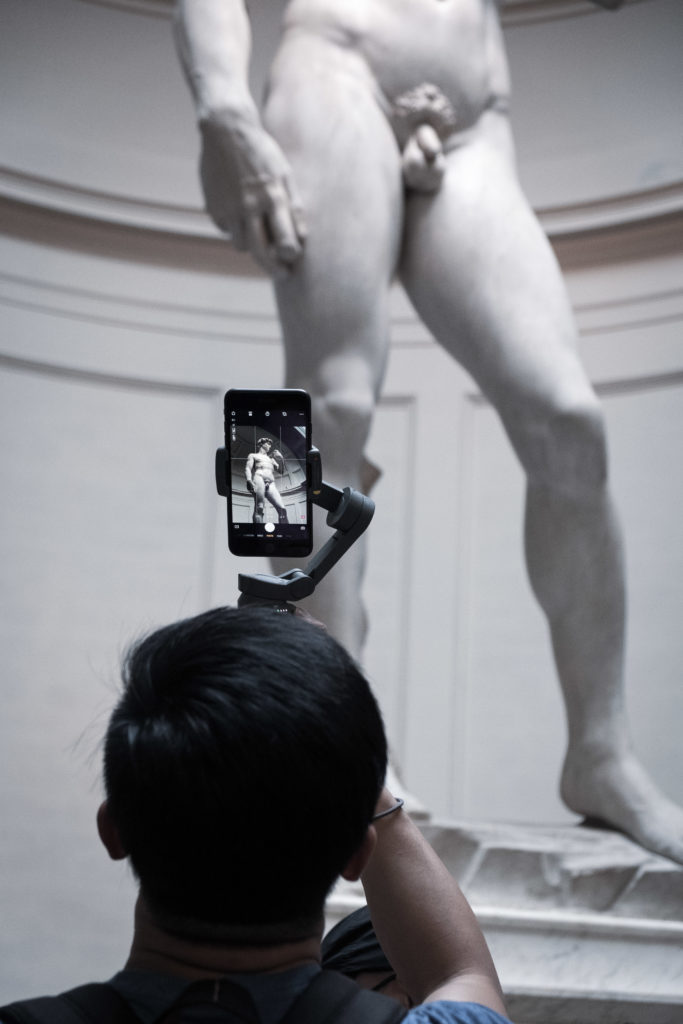 Man taking pictures of Michelangelo's David